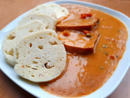 Pork shoulder slices in cream sauce with carrot, peas and dumplings. In Czech language a meal originally names Bratislavska.の写真素材