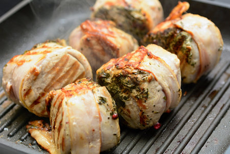 Closeup of pork tenderloin steaks grilling on the pan.の写真素材