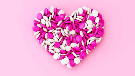 Colorful chocolate button candy chocolate coated beans Heart shaped on pink Background valentine...