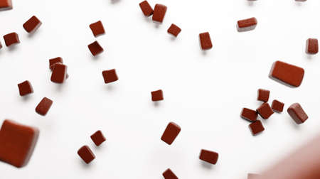 Chocolate chunks falling on isolated white floor 3d illustration 3d renderingの写真素材