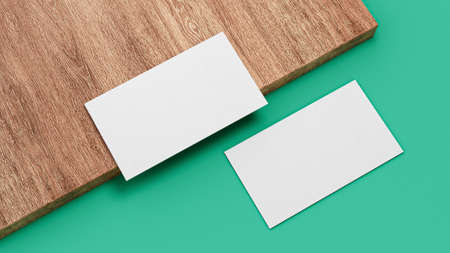 Business cards blank mockup top view, on wooden sheet and Dark Teal Green background 3d illustrationの写真素材