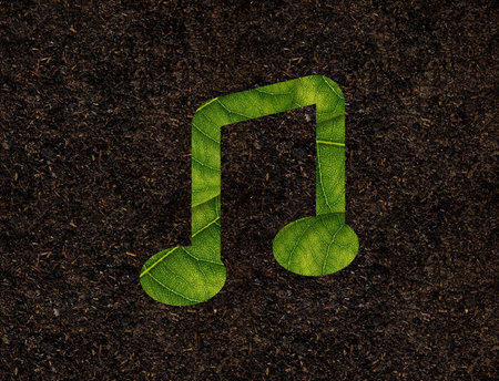 Music shape of green leaves on Soil background ecology conceptの写真素材
