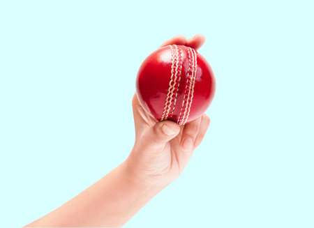 Shiny Red Test Match Leather Stitch Cricket Ball In Women Hand Closeup Photoの写真素材