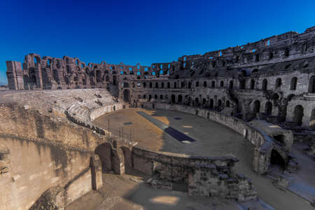 The impressive ruins of the largest colosseum in North Africa, a huge amphitheater which could hold up to 35,000 spectators, This 3rd-century monument illustrates the grandeur of Imperial ROME.の写真素材