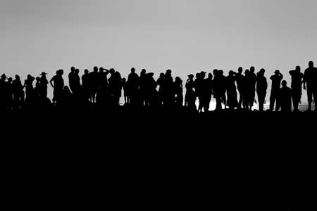 Silhouette of a group of people at the top of the mountainの写真素材