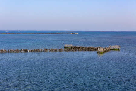 Landscape view of the sea and a wooden pier in the foregroundの写真素材