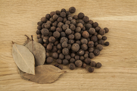 pepper and Bay leaves on wooden background