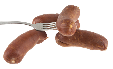 Sausages and metal fork isolated on white backgroundの写真素材