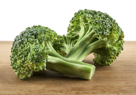 Broccoli on wooden table isolated on white backgroundの写真素材
