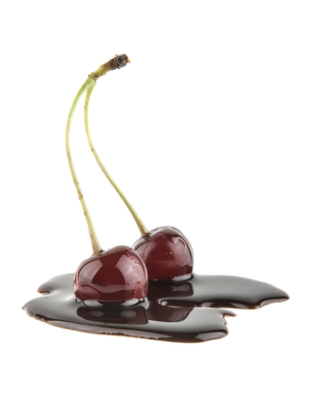 Cherry in chocolate isolated on white backgroundの写真素材