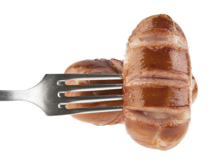fried sausage on a metal fork isolated on a white background