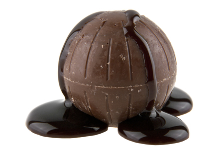 chocolate candy in liquid chocolate isolated on white backgroundの写真素材