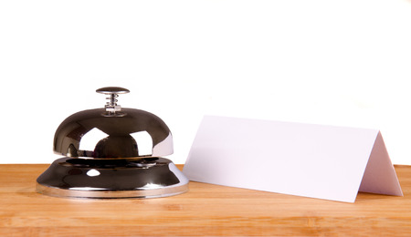 Hotel bell at the table. Isolated background.の写真素材
