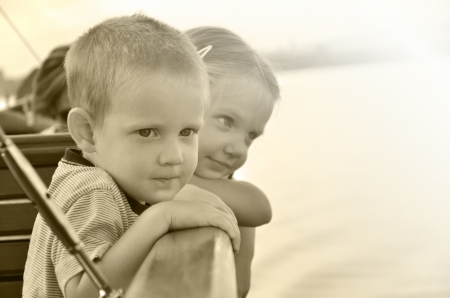 Children are looking out from a boatの写真素材