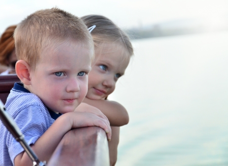 Children are looking out from a boatの写真素材