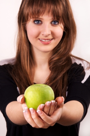 Teen girl holding an apple の写真素材