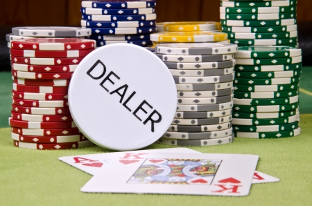 Dealer button and chips on the table の写真素材