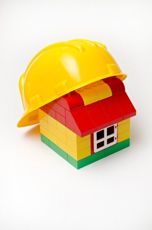 Helmet on the toy brick houseの写真素材