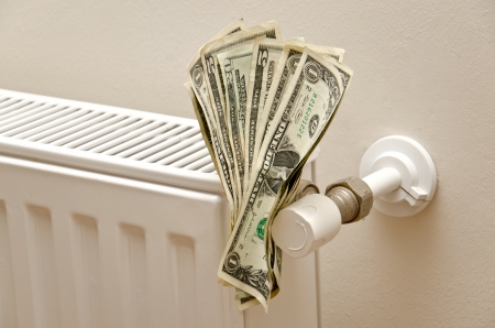 Money on a radiator  Expensive heating の写真素材