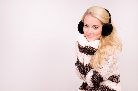 Winter girl with earmuffs in the studio の写真素材