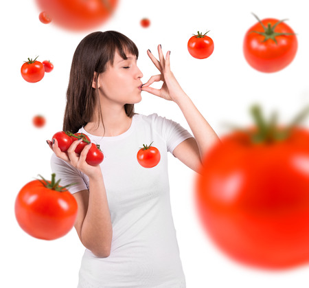 Isolated beautiful woman  with tomatoes. Perfect gesture.の写真素材