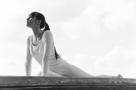 Pretty woman doing yoga exercises in the park.の写真素材