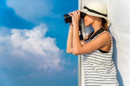Caucasian woman in white hat in the boat at summer.の写真素材