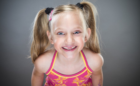 Portrait of cute smiling little girl without teeth.の写真素材