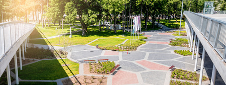 Modern park with paving and a lot of green space.の写真素材
