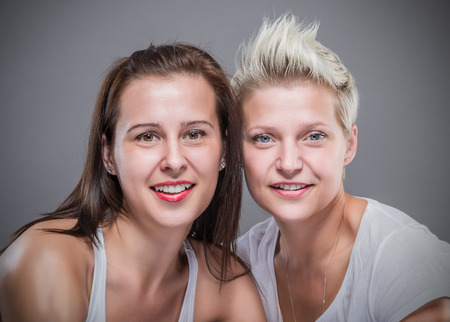 Two beautiful women laughing.の写真素材