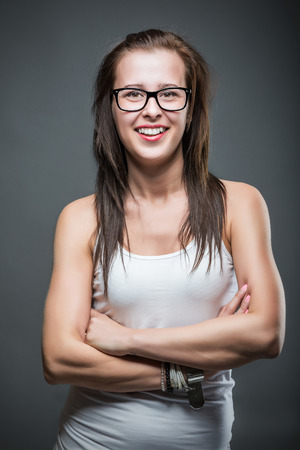 Sexy young retro woman  wearing glasses over gradient grey background.の写真素材