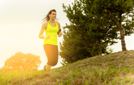 Woman Running In Countryside at beautiful sunset.の写真素材