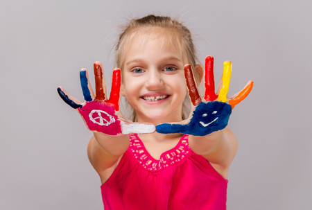 Colorful painted hands in a beautiful young girl.の写真素材