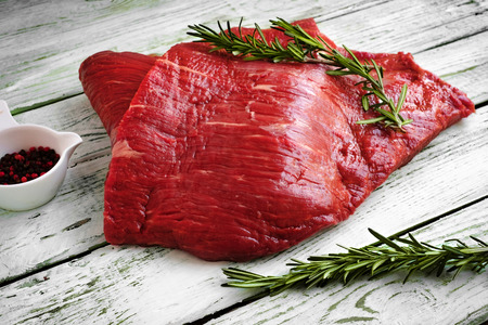 raw fillet of beef brisket on white wooden backgroundの写真素材