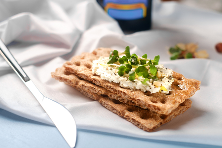 Crispbread with Cream Cheese and fresh herbs on a wooden Board, Healthy breakfast. Healthy breakfastの写真素材