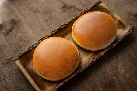 Burger buns with Golden crust on wooden backgroundの写真素材