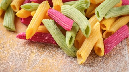 colored fresh pasta on the kitchen table, Penne home made, macroの写真素材