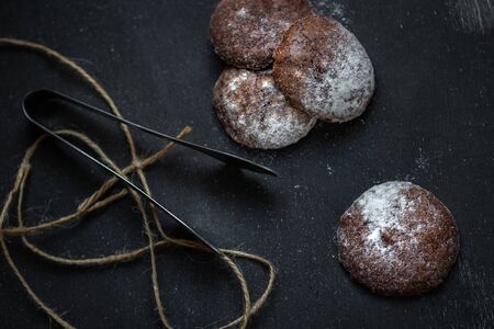 Homemade oats cookies with powdered sugar on a dark table in rustic styleの写真素材
