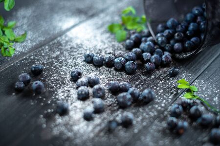 Fresh blueberries in a glass on a dark wooden background, Rustic style. Healthy food or nutrition. Macroの写真素材