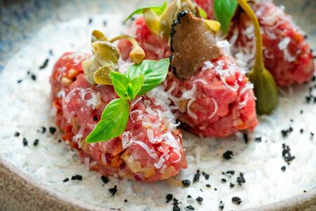 Beef tartare with mushrooms, truffle and capers on a plate. Serving in the restaurant, Haute cuisineの写真素材