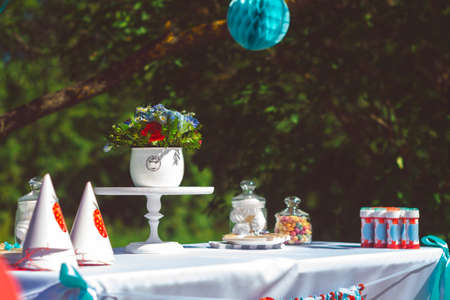 Preparations for the holiday and decorating the garden with balls and colored ribbons. Party in garden outdoors for background usage.の写真素材