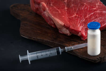 Injection of growth hormones and chemicals into raw beef. Biological experiments with antibiotics in...