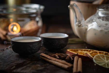 Chinese tea ceremony with ceramic cups with milk Oolong tea on wooden background. Traditional Asian drink, beautiful servingの写真素材