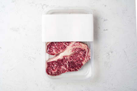 Raw beef Striploin steak in vacuum packaging, mockup for the logo design ideaの写真素材