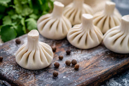 Raw baozi dumplings on wooden boardの写真素材