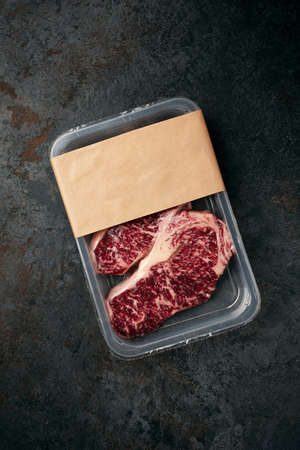 Raw beef Striploin steak in vacuum packaging, mockup for the logo design ideaの写真素材