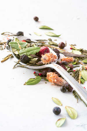 Dried herbal tea with berries on a teaspoonの写真素材