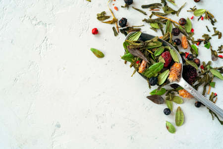 Dried herbal tea with berries on a teaspoon, top view and copy spaceの写真素材