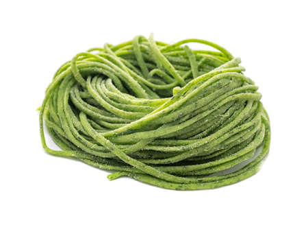 Fresh organic raw spaghetti pasta with spinach isolated on white backgroundの写真素材