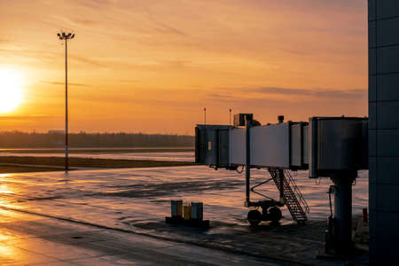 A quiet and empty airport with a view of the taxiway and the airplane tubeの写真素材